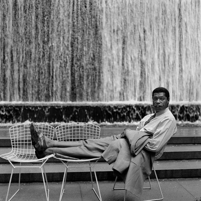 Actor Laurence Fishburne is shown seated in Harry Bertoia's Side Chairs. Photograph by unknown photographer.