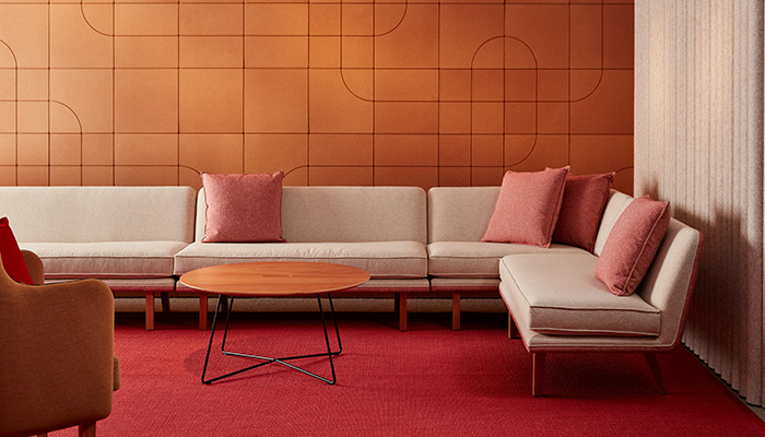 Rockwell Unscripted lounge furniture and occasional tables with Spinneybeck Beller Collection cork wall tiles.