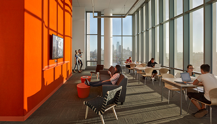 Informal student lounge area with Antenna® Tables, Maya Lin stones, Risom Lounge Chairs and Sprite Stacking Chairs
