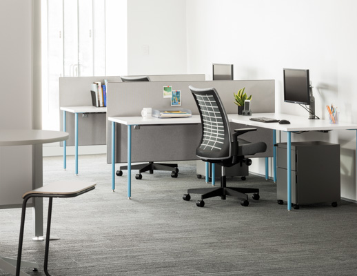 Knoll Antenna Simple tables with blue legs for primary workstations