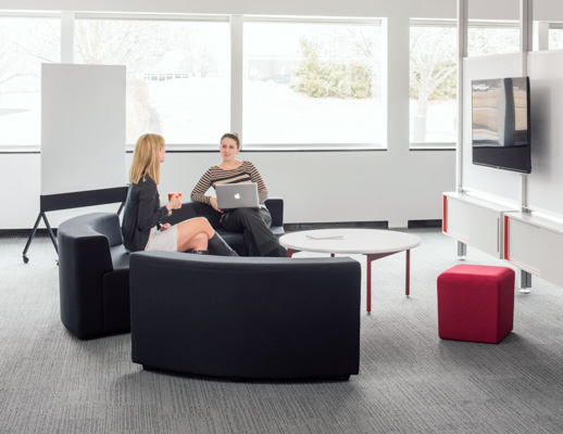 Knoll white Antenna low table with red legs, grey k. lounge and Interpole for Activity Spaces and other meeting spaces.